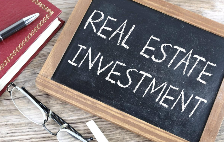 a sign that says real estate investment