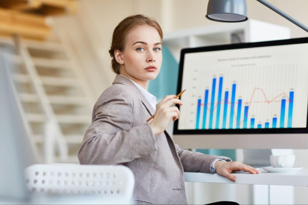 a young female financial analyst doing business research with a graph in the background