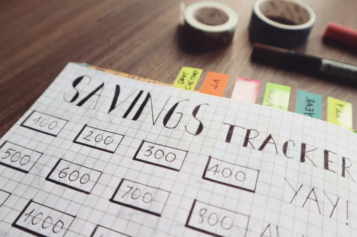 the inscription saving tracker in the notebook on the table